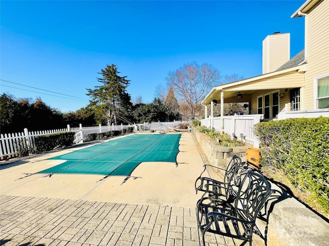 view of pool featuring a patio area, fence, and a fenced in pool