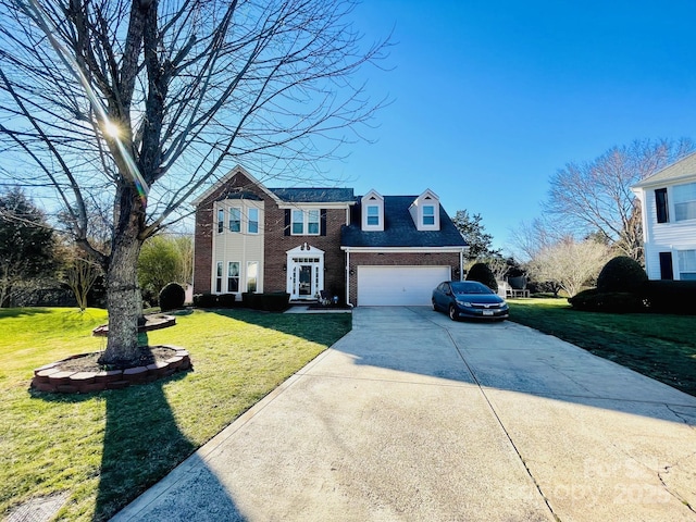 view of front facade featuring a garage, brick siding, driveway, and a front yard