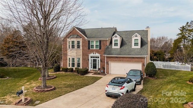 colonial inspired home with driveway, a garage, fence, a front lawn, and brick siding