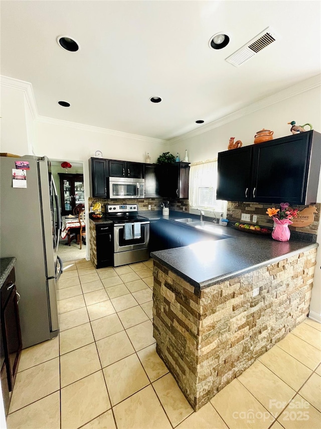 kitchen featuring light tile patterned floors, stainless steel appliances, dark countertops, and visible vents