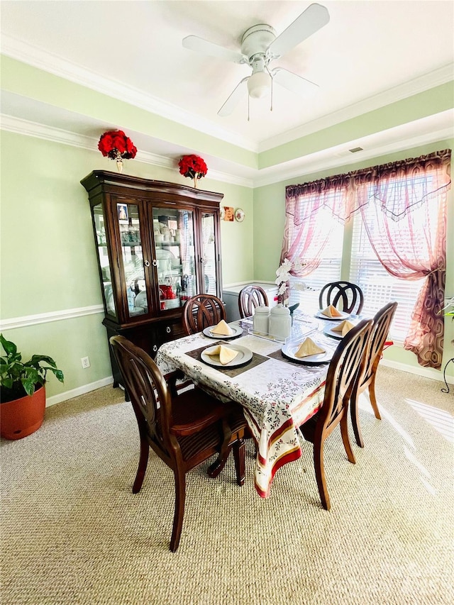 carpeted dining room with crown molding and a healthy amount of sunlight