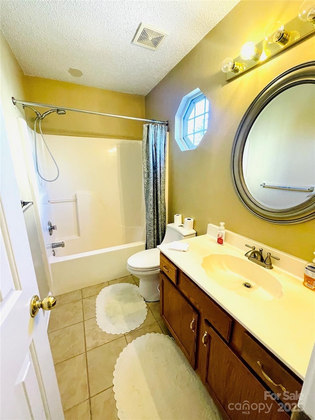 full bathroom with visible vents, toilet, vanity, a textured ceiling, and tile patterned floors