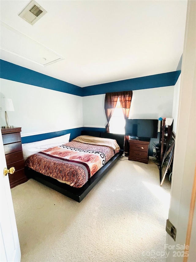 bedroom with visible vents and carpet flooring