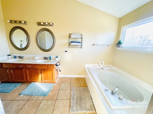 full bath featuring double vanity, a garden tub, a sink, and tile patterned floors