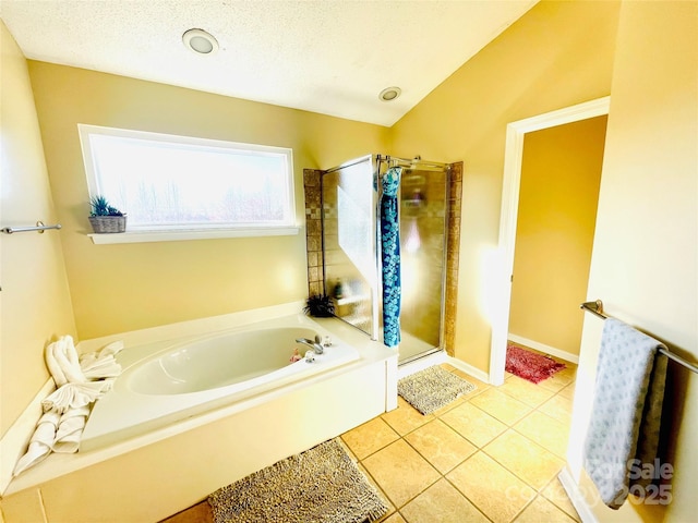 full bath with tile patterned flooring, a shower stall, a textured ceiling, and a bath