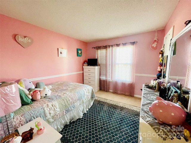 carpeted bedroom with a textured ceiling