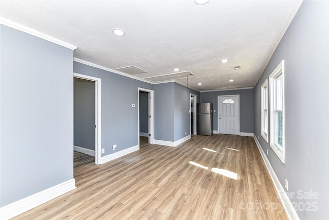 unfurnished living room with baseboards, ornamental molding, and light wood-style floors