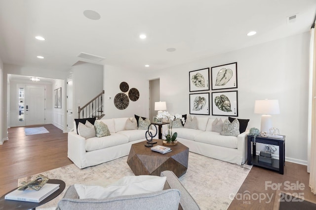 living room featuring recessed lighting, visible vents, stairway, and wood finished floors