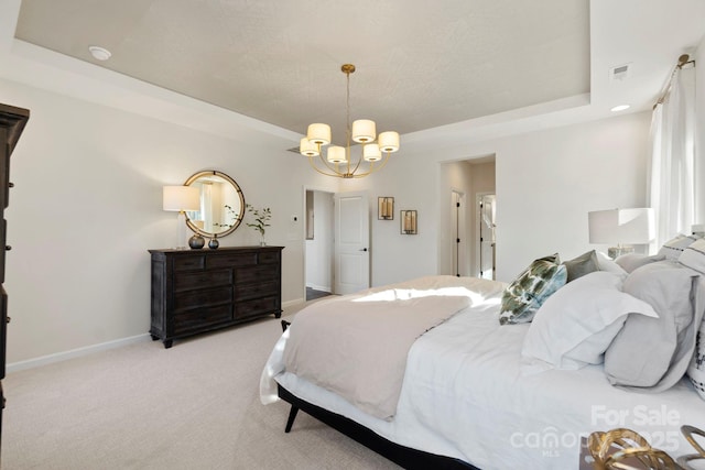 bedroom with light carpet, baseboards, visible vents, a raised ceiling, and a chandelier