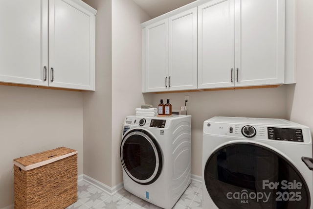 clothes washing area featuring light floors, independent washer and dryer, cabinet space, and baseboards