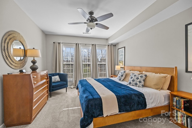 carpeted bedroom with ceiling fan and visible vents