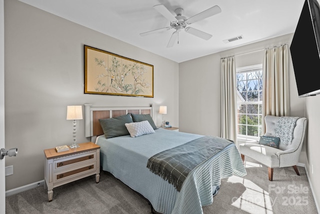 carpeted bedroom featuring a ceiling fan, visible vents, and baseboards