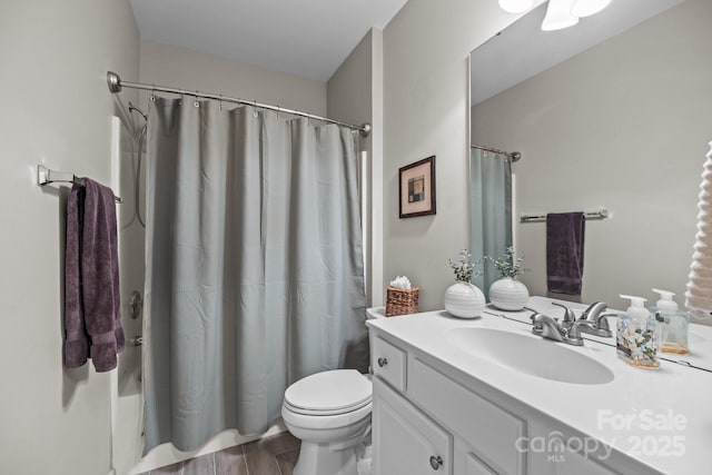 bathroom featuring shower / tub combo, vanity, toilet, and wood finished floors