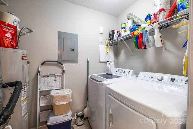 clothes washing area featuring washer and dryer, laundry area, water heater, and electric panel