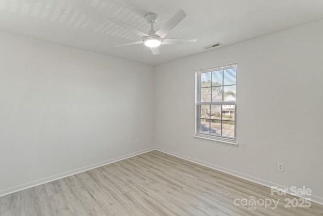 unfurnished room with light wood-type flooring, visible vents, ceiling fan, and baseboards