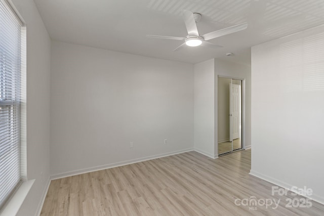 empty room with baseboards, light wood-style flooring, and a ceiling fan