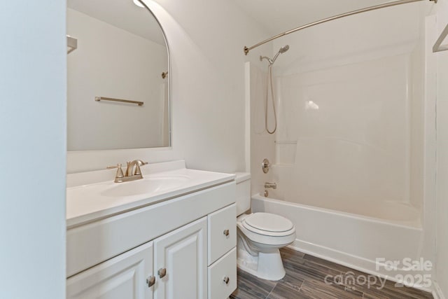 full bath with wood finished floors, vanity, toilet, and bathing tub / shower combination