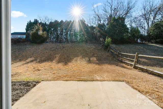 view of yard featuring fence and a patio