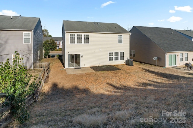 rear view of house featuring a patio, central AC unit, and fence