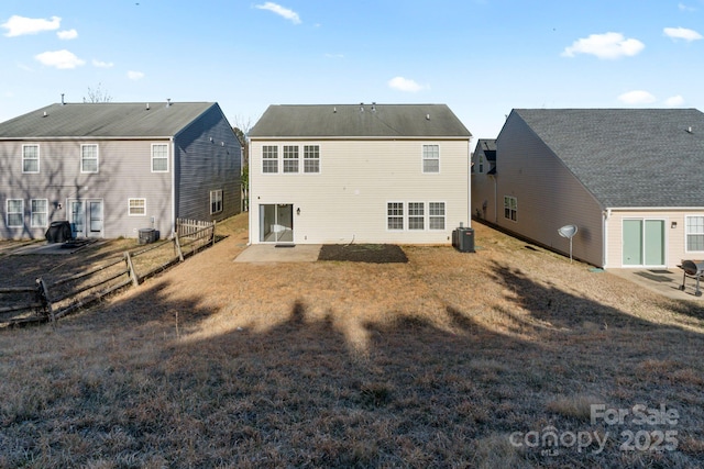 back of house featuring a residential view, fence, cooling unit, a yard, and a patio area