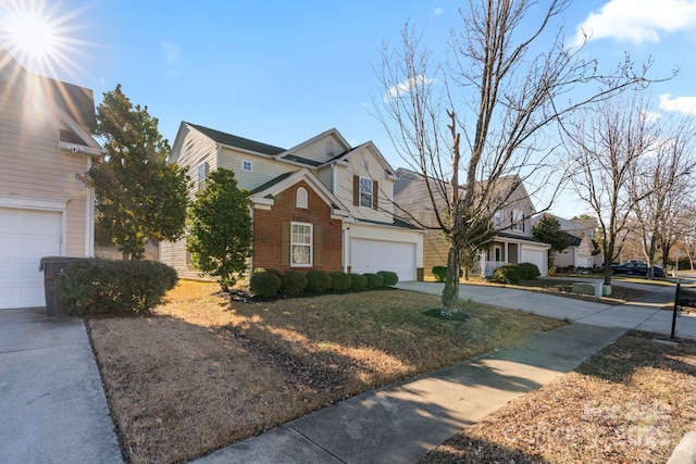 view of front facade with a residential view, concrete driveway, and brick siding