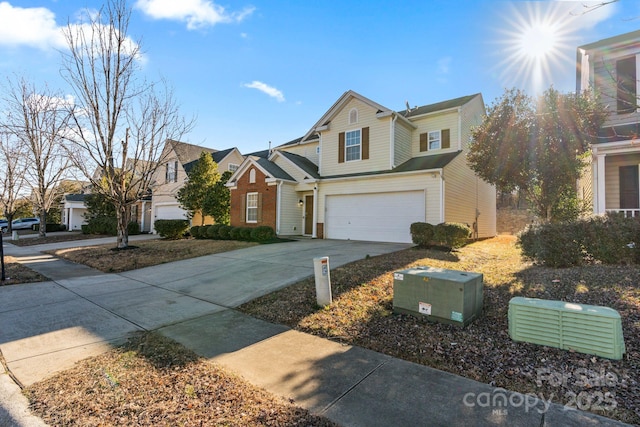 traditional home featuring a garage, a residential view, and concrete driveway