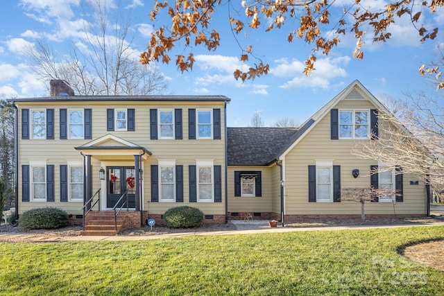 colonial-style house featuring a front lawn, crawl space, a chimney, and a shingled roof