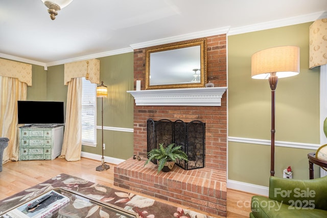 living area featuring a brick fireplace, crown molding, and wood finished floors