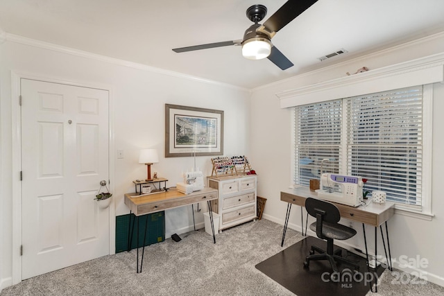 office featuring light carpet, baseboards, visible vents, a ceiling fan, and ornamental molding