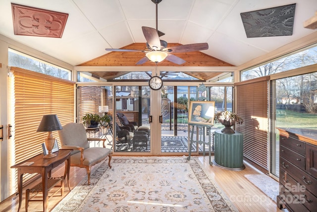 sunroom / solarium featuring vaulted ceiling, ceiling fan, and plenty of natural light