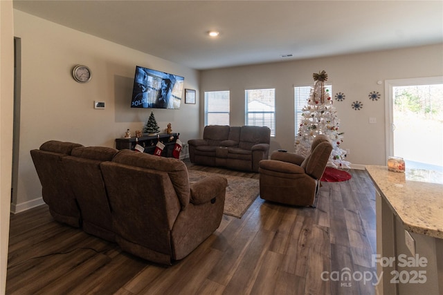 living area featuring dark wood-style floors and baseboards