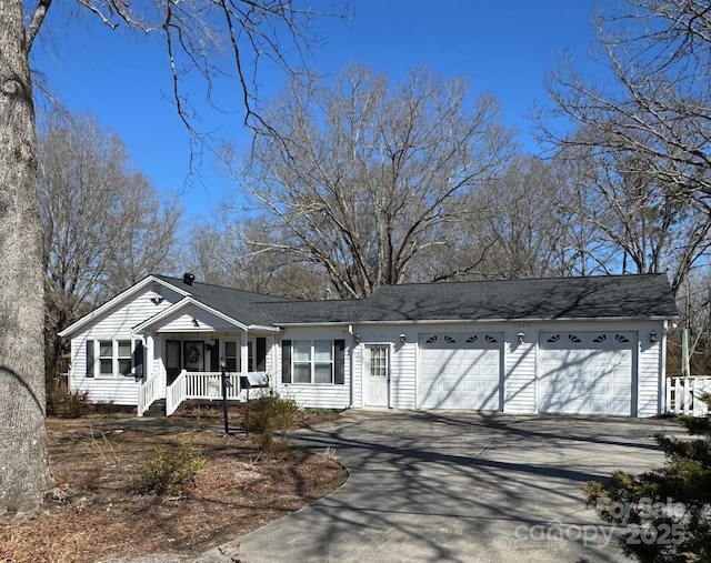 ranch-style home featuring a garage, driveway, and a porch