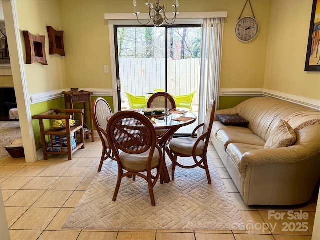 dining room featuring an inviting chandelier and light tile patterned floors