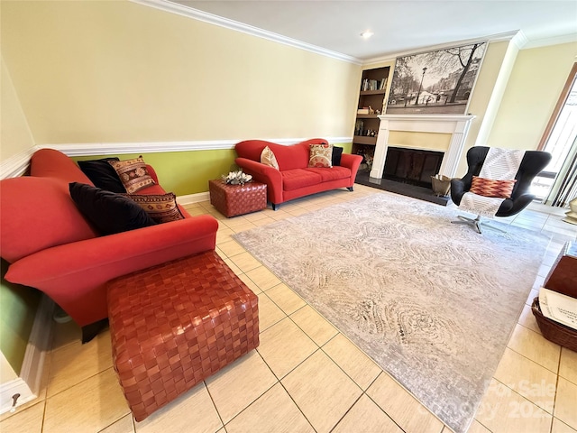 tiled living room featuring ornamental molding, a glass covered fireplace, baseboards, and recessed lighting