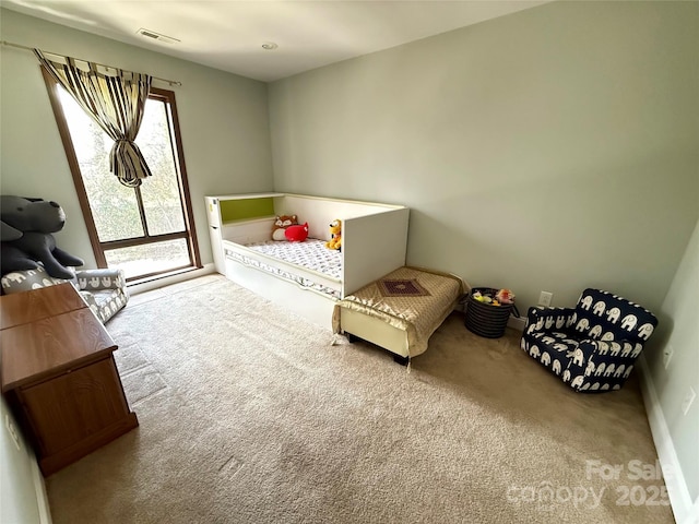 carpeted bedroom featuring visible vents