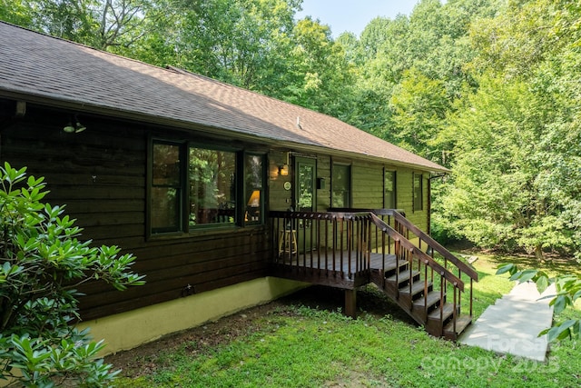 exterior space with roof with shingles