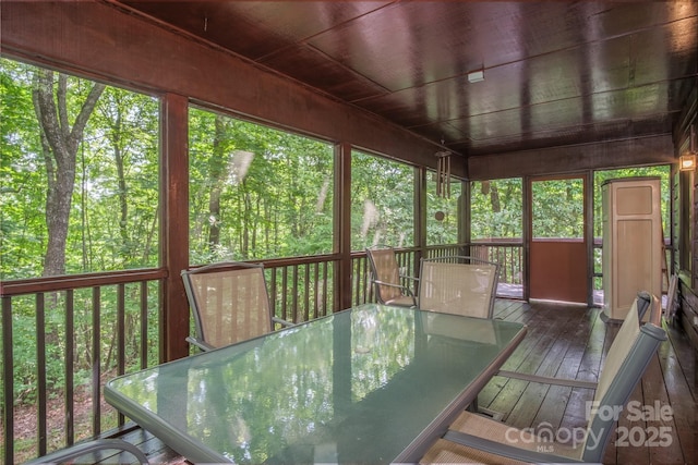 unfurnished sunroom with wooden ceiling and a wealth of natural light