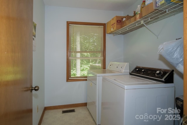 laundry area featuring laundry area, baseboards, visible vents, and washer and dryer