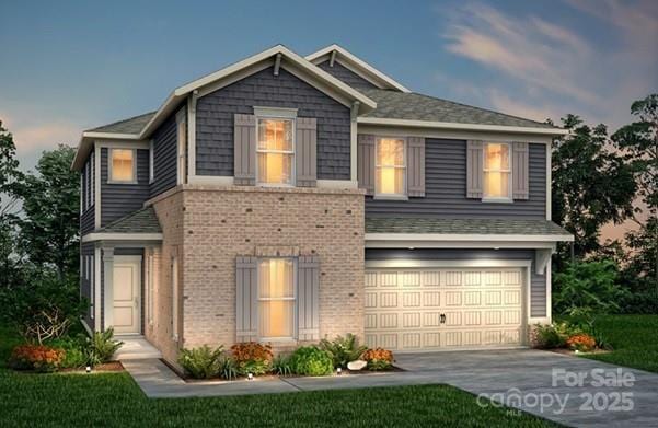 view of front of house with an attached garage, concrete driveway, and brick siding