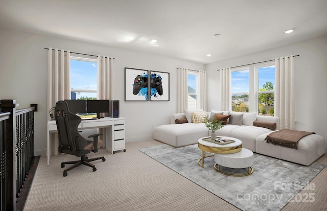 interior space featuring recessed lighting, light carpet, plenty of natural light, and baseboards