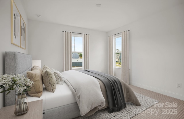 bedroom with light carpet and baseboards