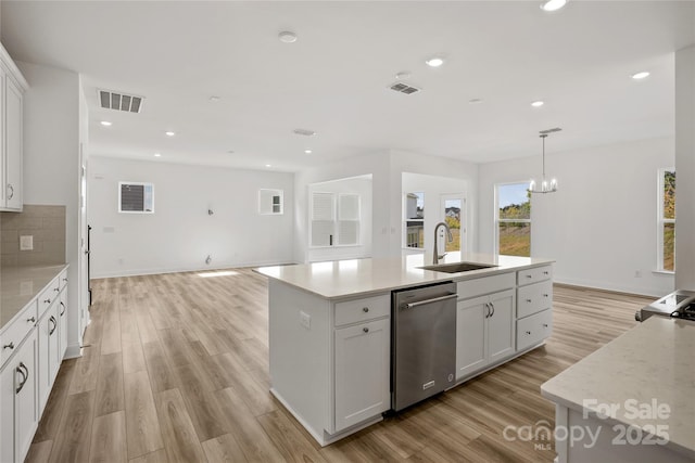 kitchen featuring a sink, white cabinetry, visible vents, and dishwasher