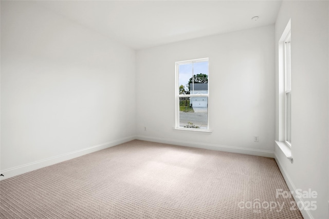 carpeted spare room with baseboards