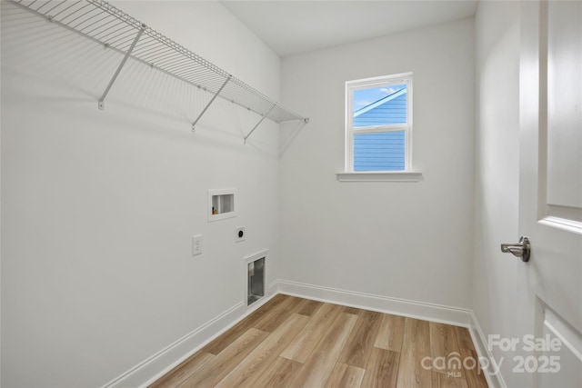 laundry room with laundry area, baseboards, hookup for a washing machine, light wood-type flooring, and electric dryer hookup