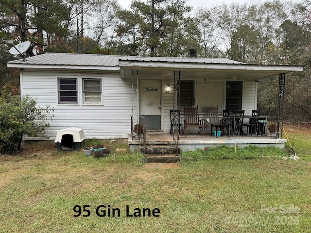 bungalow with metal roof, a front lawn, and a porch