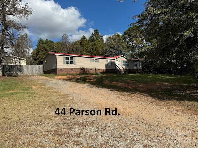 manufactured / mobile home with crawl space, fence, and a front lawn