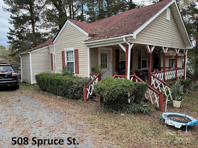 view of front of house with covered porch and roof with shingles