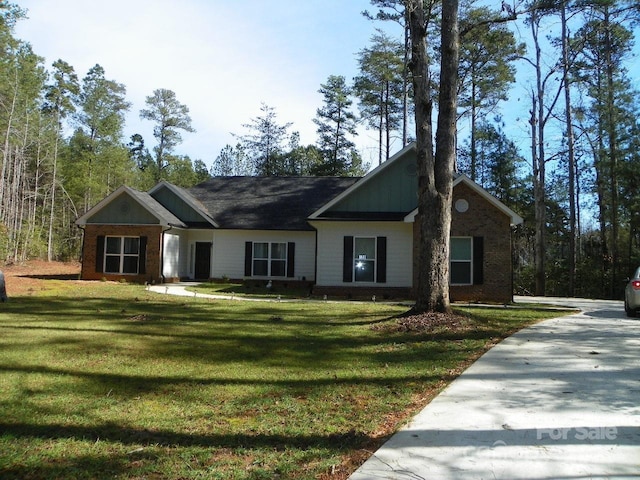 128 Summerlake Dr, New London, NC 28127 - view of front of house featuring brick siding and a front lawn