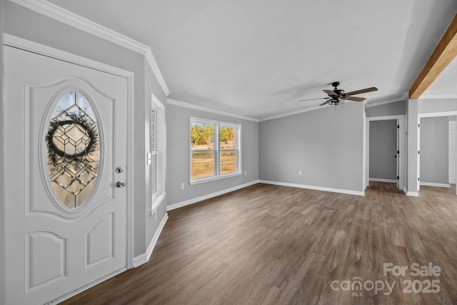 foyer with dark wood-type flooring, ornamental molding, baseboards, and a ceiling fan