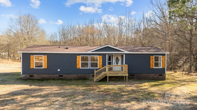 manufactured / mobile home featuring crawl space and a front lawn